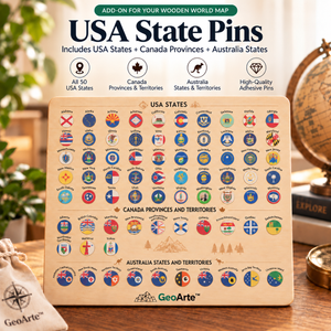GeoArte USA State Pins wooden world map pin set on a wooden board, displayed on a tabletop with a globe, books, and a small drawstring pouch in the background.